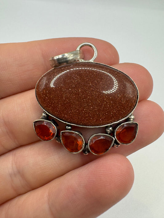 Silver goldstone and topaz pendant