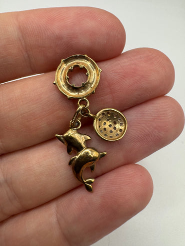 9ct gold diamond dolphin, disc and life raft pendant