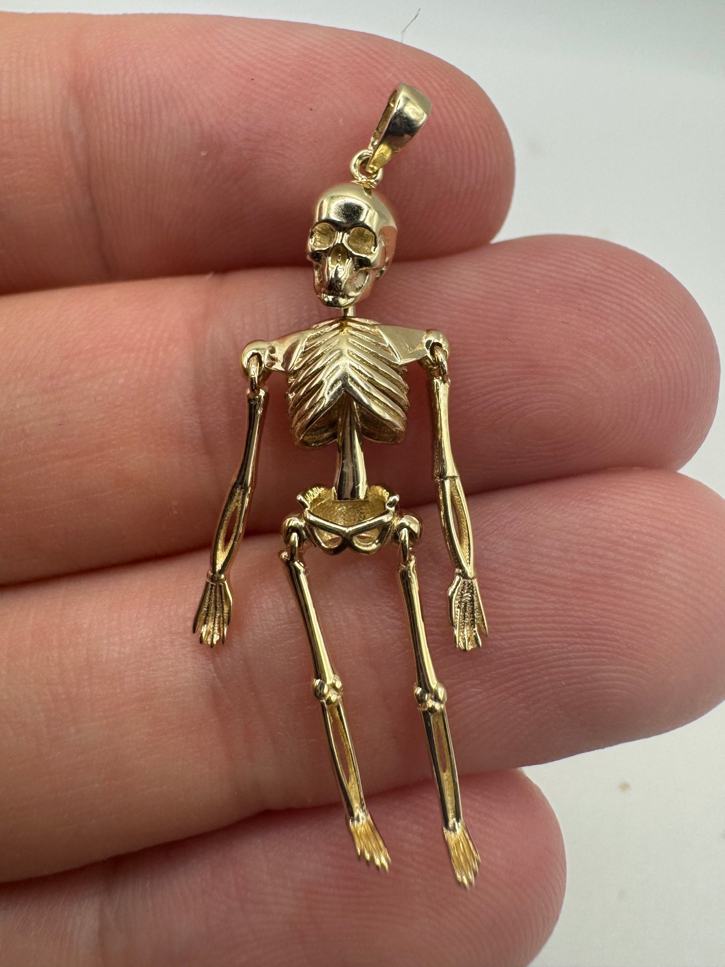 9ct gold articulated skeleton pendant