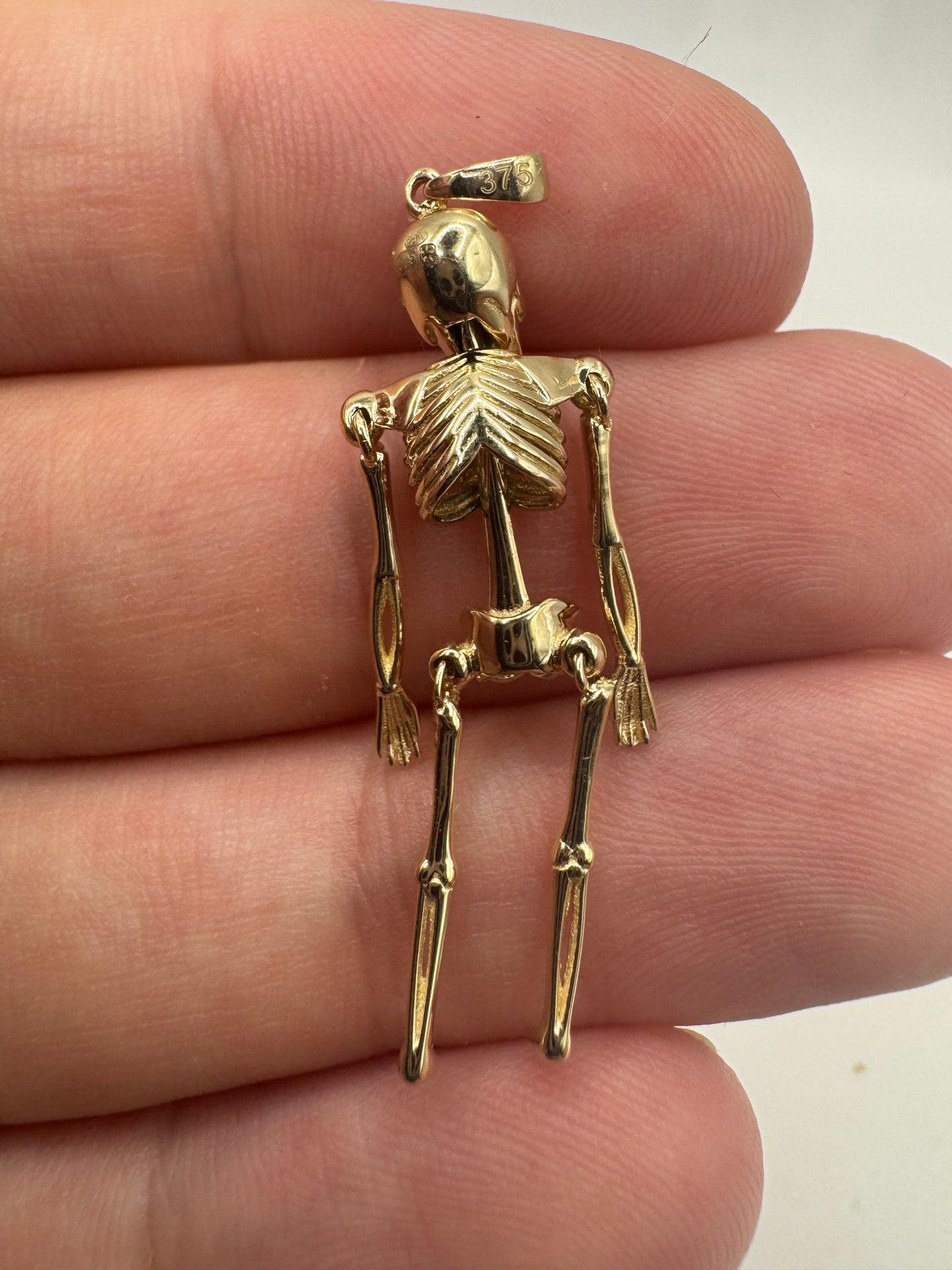 9ct gold articulated skeleton pendant